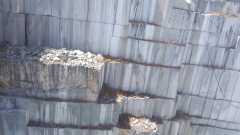 Quarry bench showing quartz vein deposits