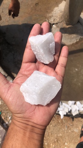 White quartz sample held at mine site